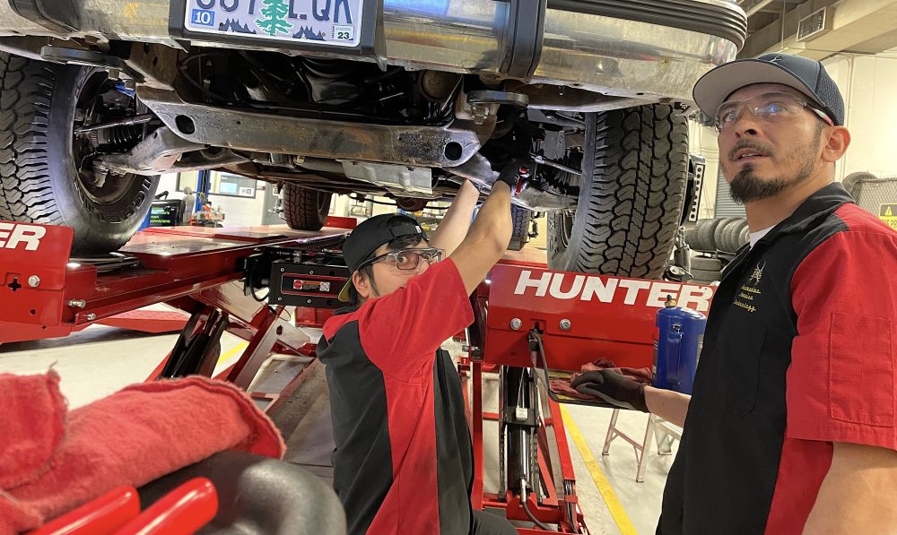 Students work on car