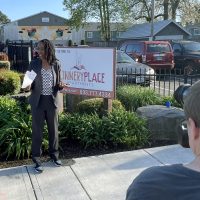 Dr. Bennings provides remarks to a small group in front of Connery Place.