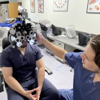 Vladislav Kirilov in lab checking student's vision