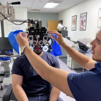 Vladislav Kirilov in lab checking student's vision