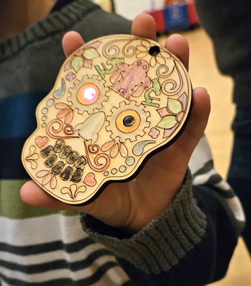 During St. Helens' Dia De Los Muertos event PCC collaborated with children to build light-up Sugar Skull kits.
