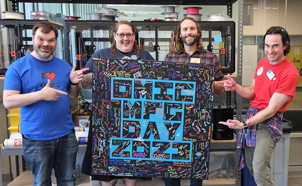 STEM Center coordinators holding sign