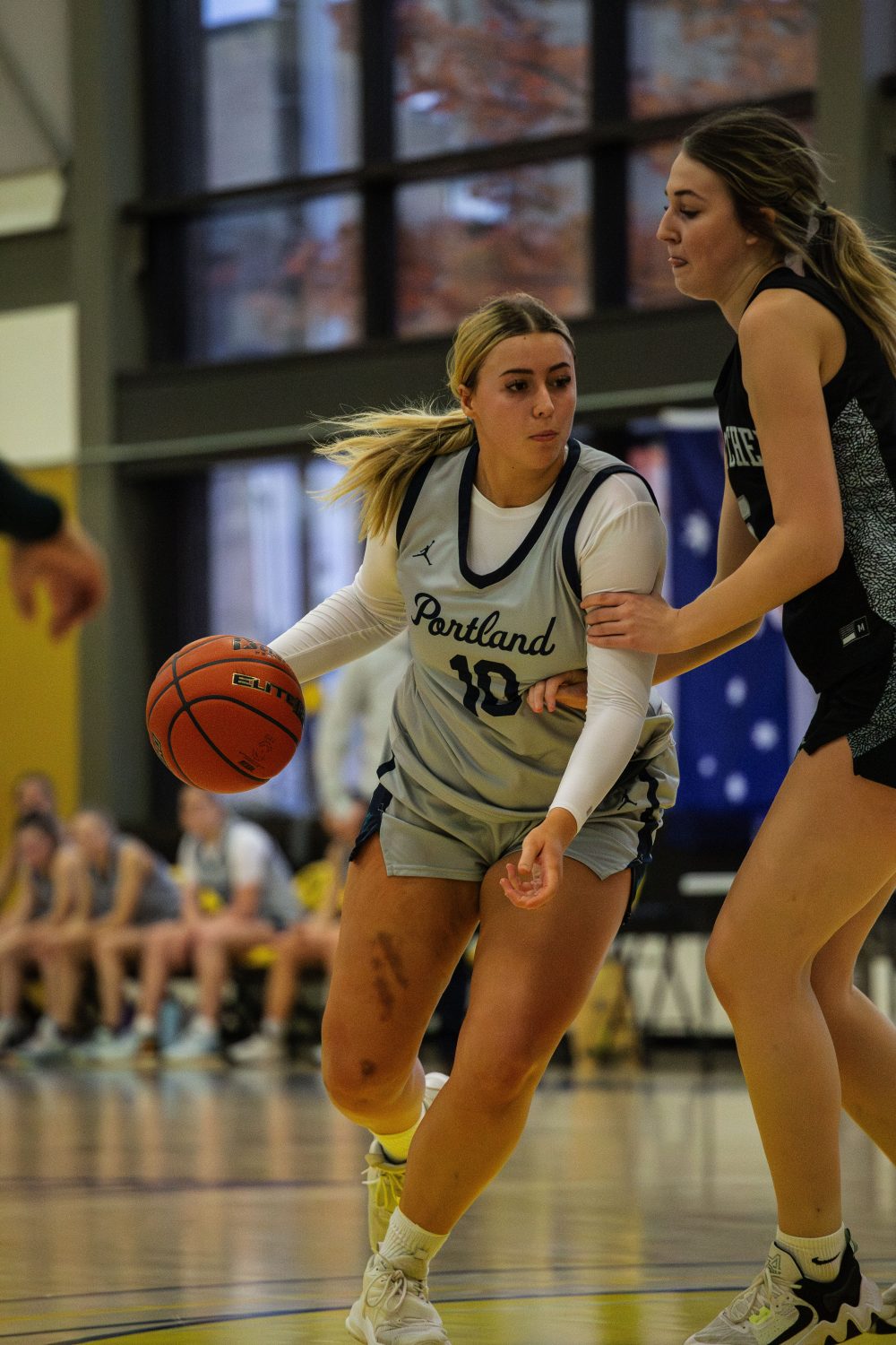 Panther Women's Basketball forward dribbles down court.