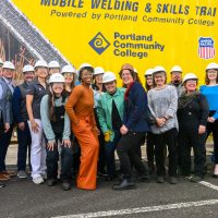 Group photo in front of mobile welding center.