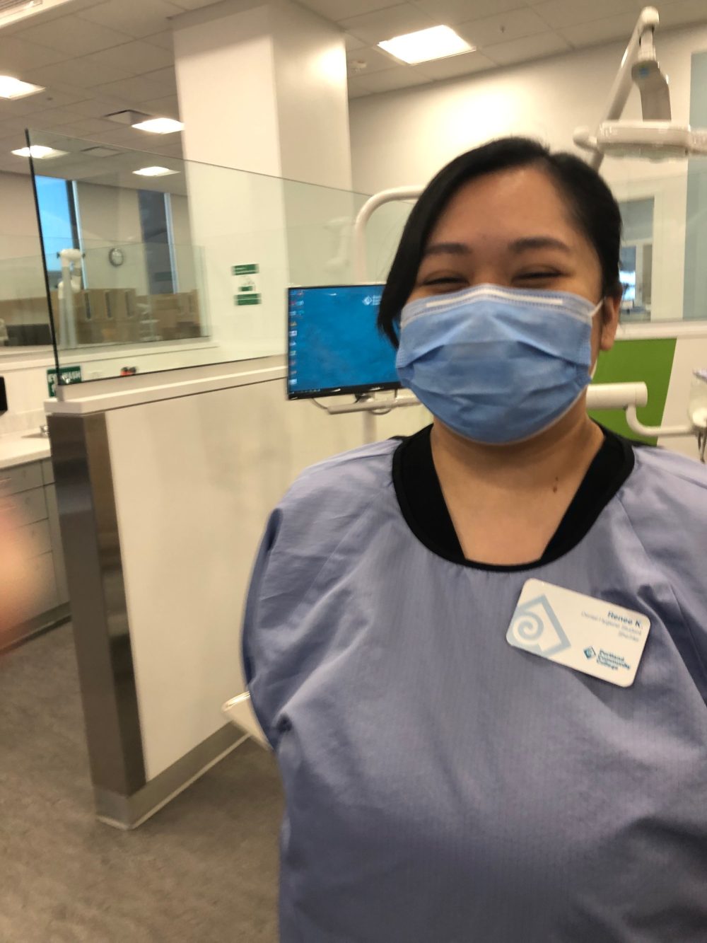 Masked female student at dental clinic.