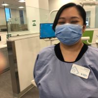 Masked female student at dental clinic.