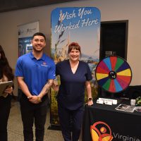 Three people gather at RN exhibit.
