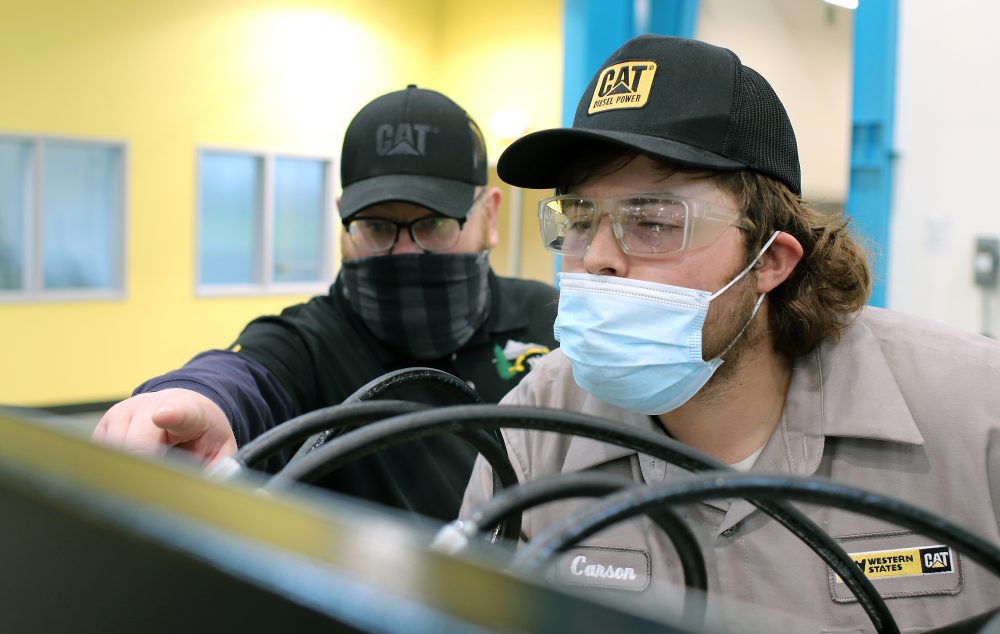 Students in Dealer lab focused on engine