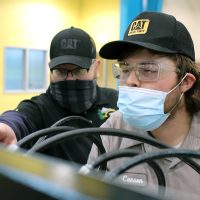 Students in Dealer lab focused on engine