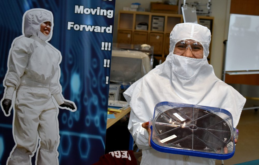 Glencoe student dons the bunny suit while holding a semiconductor chip.