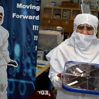 Glencoe student dons the bunny suit while holding a semiconductor chip.