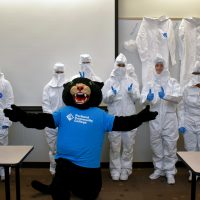 Poppe with high school students in bunny suits
