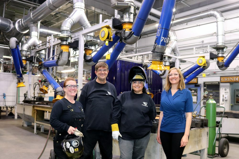 Juanita Lopez-Escobar (second from right) with instructor and mentor Kali Giaritta (far right) at the state-of-the-art Rock Creek Campus Welding Shop.