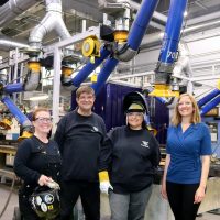 Juanita Lopez-Escobar (second from right) with instructor and mentor Kali Giaritta (far right) at the state-of-the-art Rock Creek Campus Welding Shop.