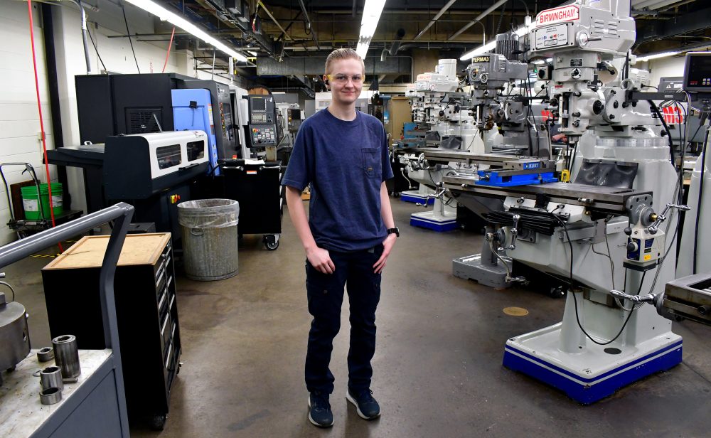 Kennedy Godfrey standing in Sylvania machining shop.