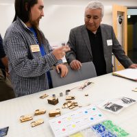 Sebastian Bishop (program coordinator with Hacienda CDC) shows Ernesto Fonseca (Hacienda CEO) items made in the learning center.