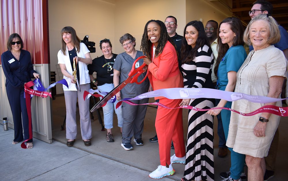 With Scissors, from left, Ragan Borzcik, PCC Veterinary Technology Program chair and PCC President Adrien Bennings. Pam Treece, Washington County commissioner, far right.