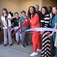 With Scissors, from left, Ragan Borzcik, PCC Veterinary Technology Program chair and PCC President Adrien Bennings. Pam Treece, Washington County commissioner, far right.