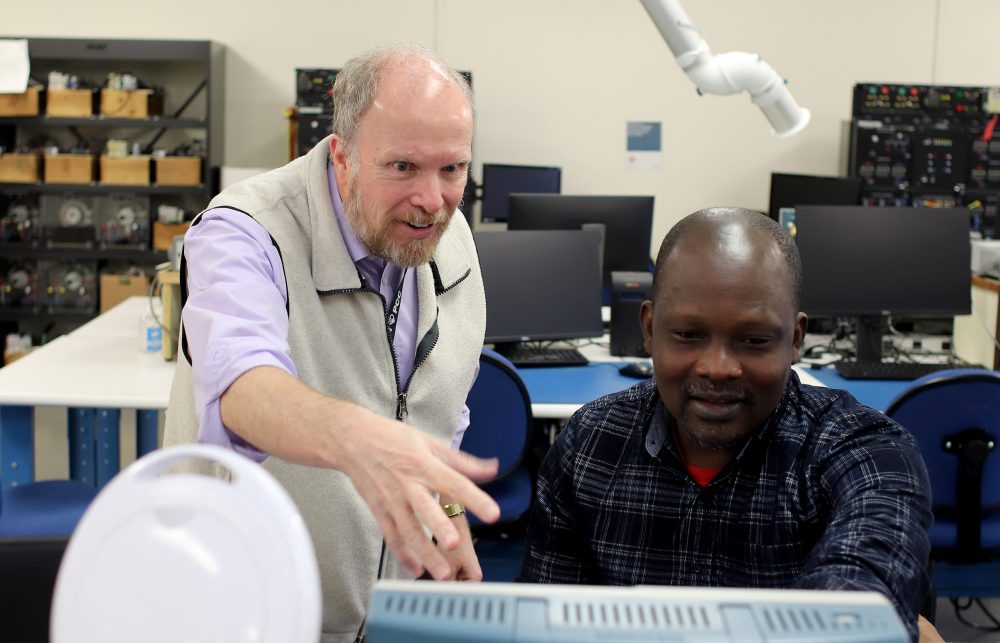 Instructor and student in EET lab