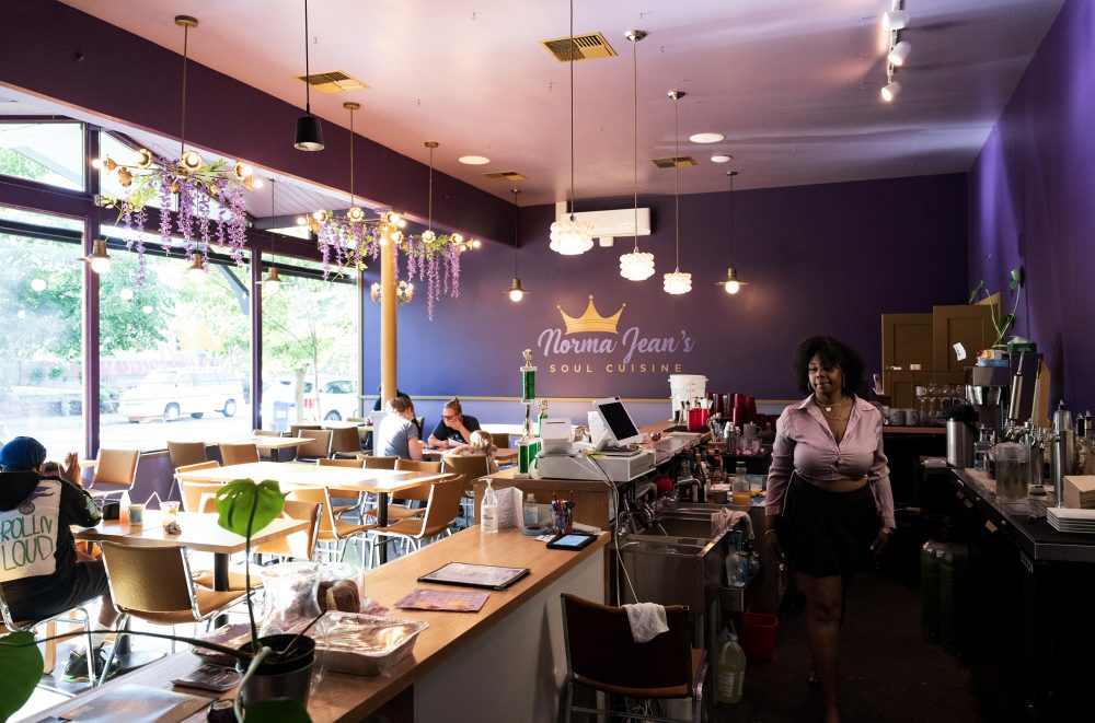 Interior of restaurant as waitress walks by customers