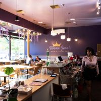Interior of restaurant as waitress walks by customers