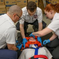 Students work on a fellow classmate.