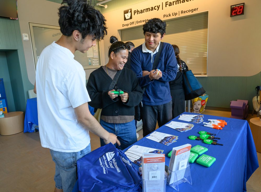 Customers checking out info desk.