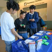 Customers checking out info desk.