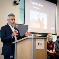 Lam Research Corporate VP and GM Aaron Fellis addresses the graduating class of the company's first-ever Microscopy Technician Training Program, remarking on the importance of workforce development for in-demand roles within the fast-growing semiconductor industry.