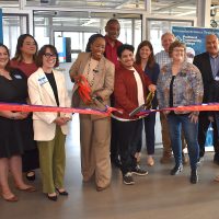 Group ribbon-cutting in new Teaching Cleanroom at Willow Creek Opportunity Center.