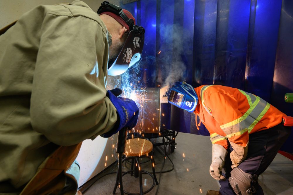 Matt Scott inspects the technique of one of his students during open shop.