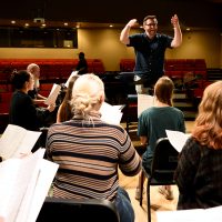 Sam Barbara conducting choir practice.