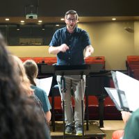 Sam Barbara conducting choir practice.