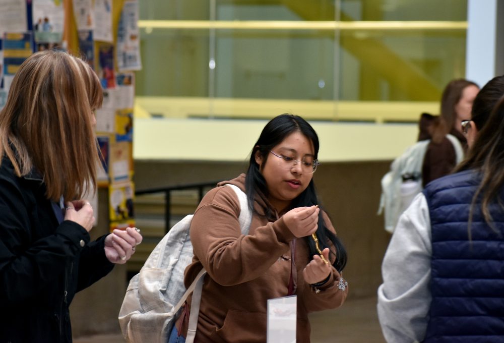 A customer analyses the goods at Dec. 3's ESOL jewelry sale.