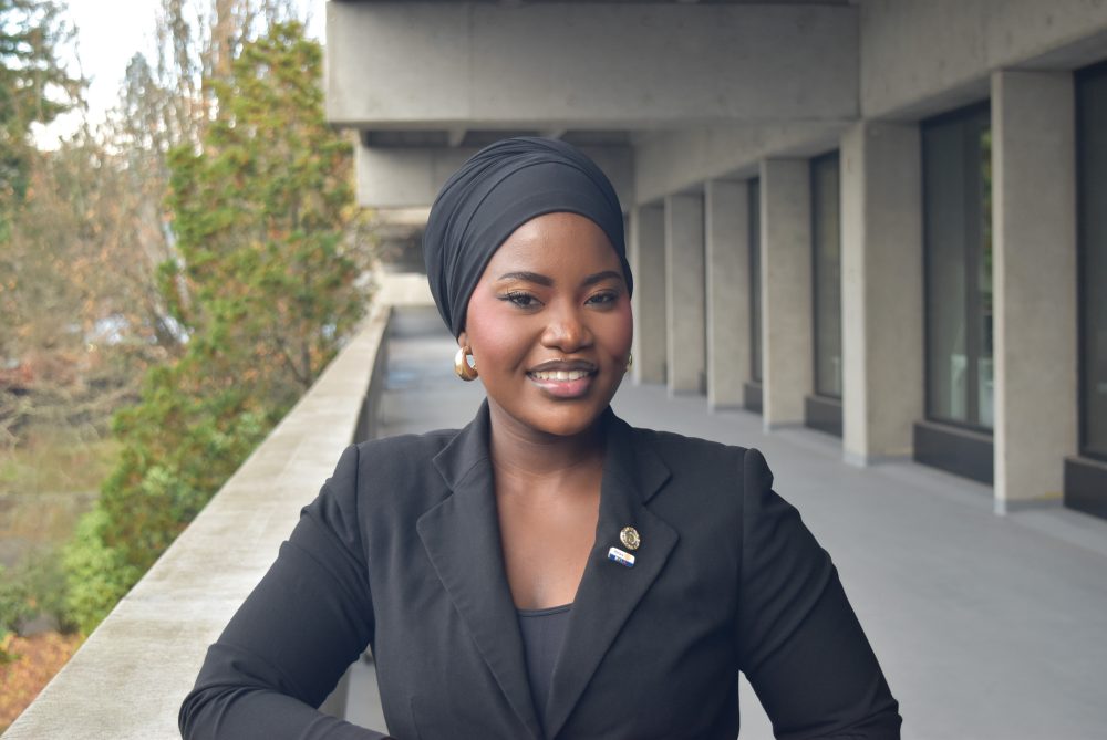 Woman in headwrap smiles.