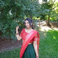 Young woman in red and gold Indian sari.