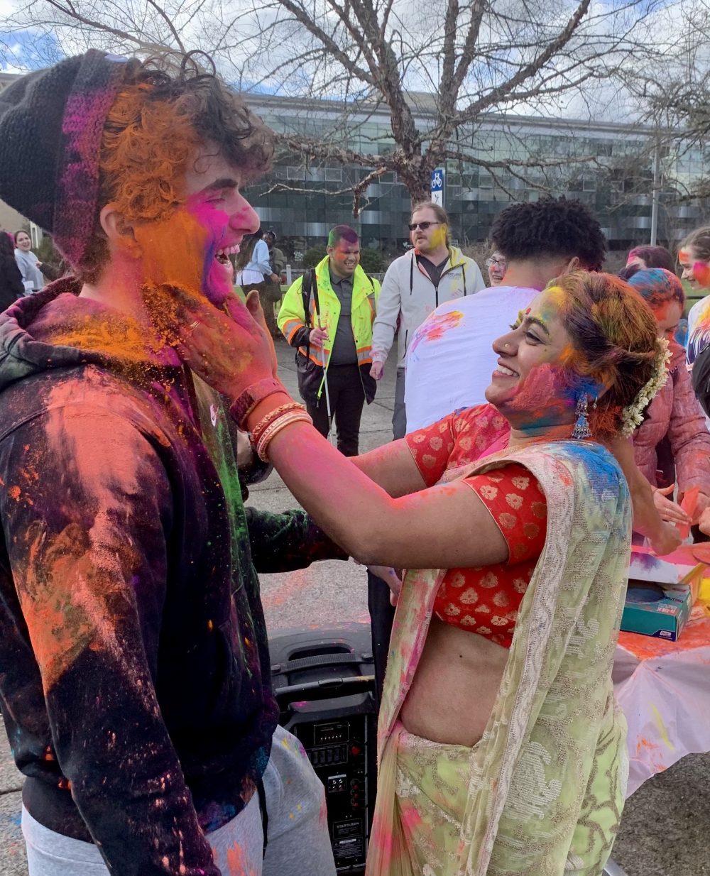 Payal Roy smears color on a student.