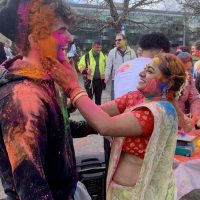 Payal Roy smears color on a student.