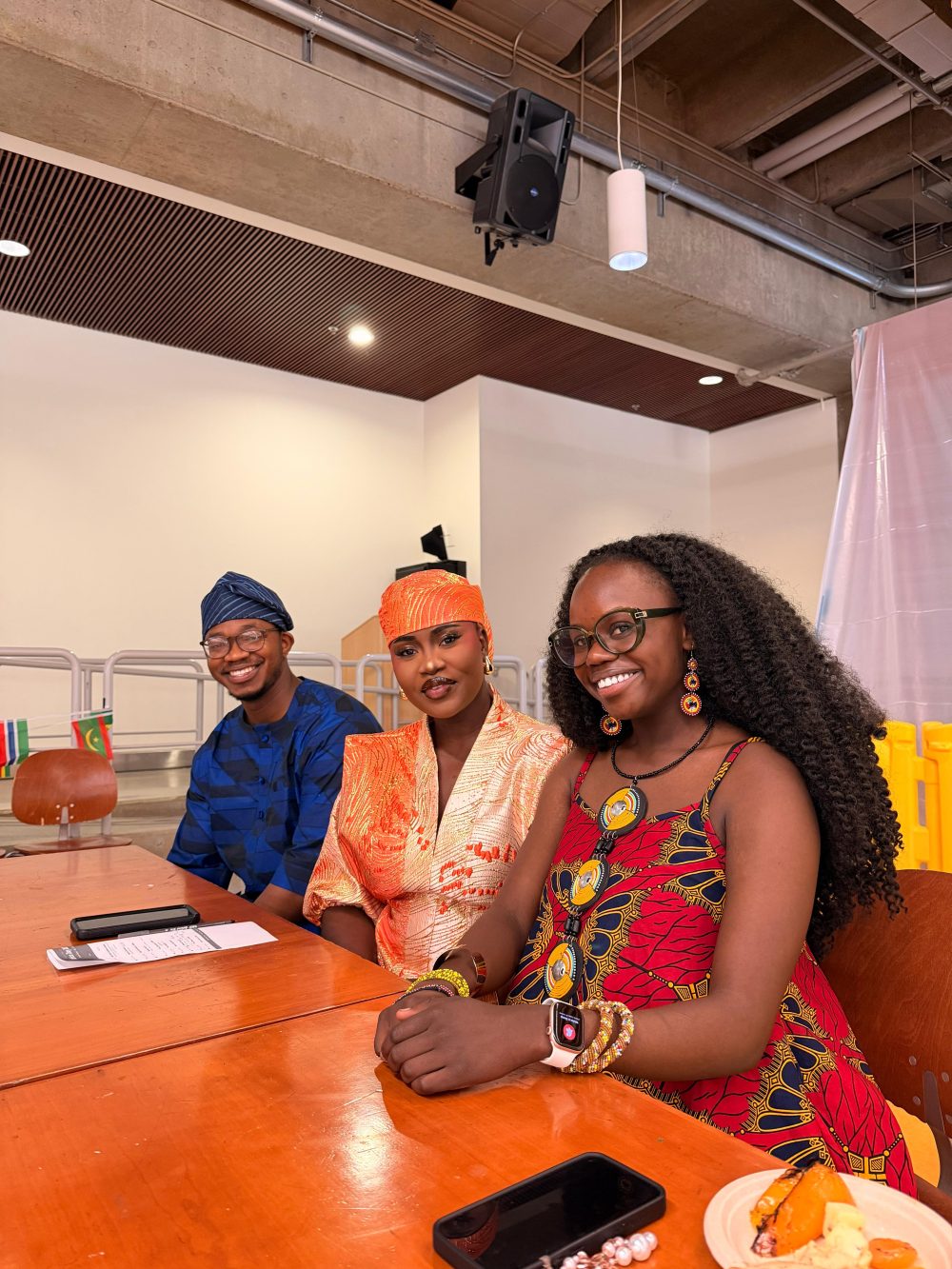 African students seated at table in national costumes for PCC African Students Union.