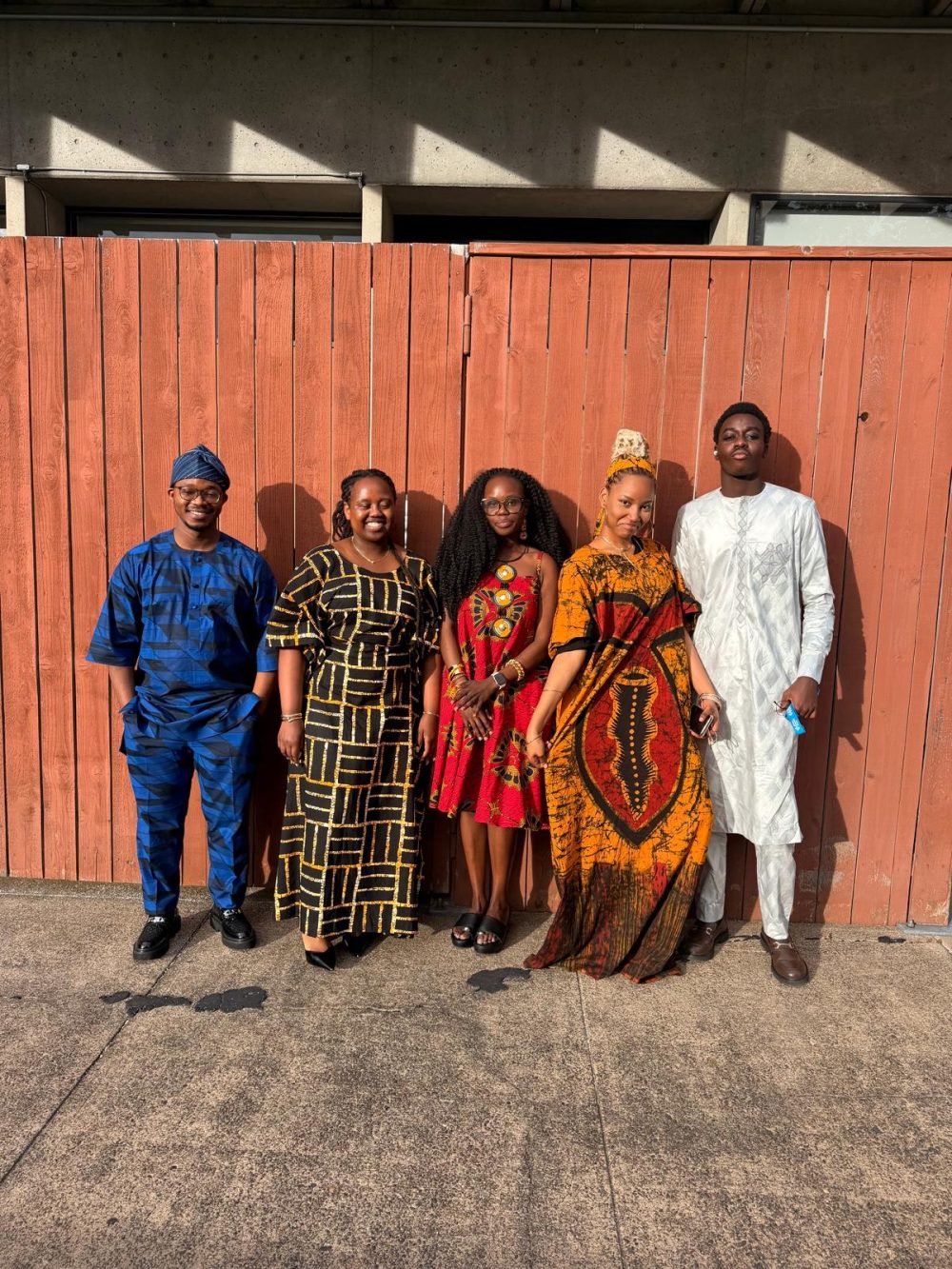 African Students of PCC wear vibrant textiles and clothing from their homeland including head scarves, dresses and one white suit.