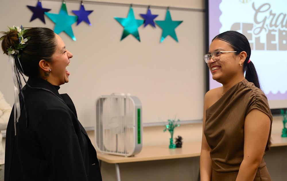 Alejandra Heredia Cepeda talks to a fellow international ed grad.