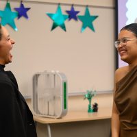 Alejandra Heredia Cepeda talks to a fellow international ed grad.