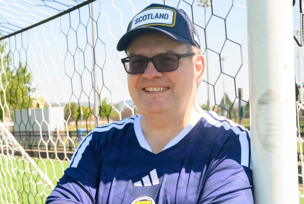 John MacLean in front of soccer goal net.