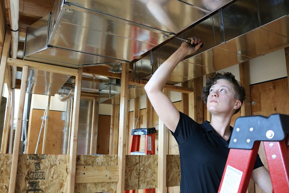 Leslie Smith, PCC alum, works on HVAC building systems at the Swan Island Training Center.