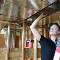 Leslie Smith, PCC alum, works on HVAC building systems at the Swan Island Training Center.