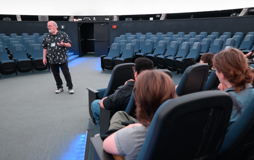 Todd teaches his class at OMSI's planetarium.