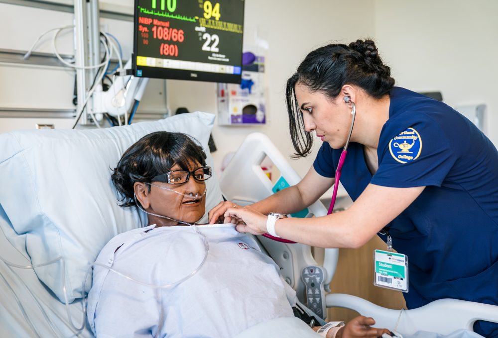 Nurse training on patient.