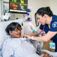 Nurse training on patient.