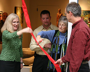 Sharon Helzer, Dick's wife, cuts the ceremonial ribbon to officially open the Helzer Art Gallery.