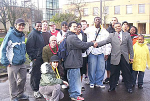 Algie Gatewood shakes the hand of James Bloomfield and fellow POIC students following a clean up of the campus.
